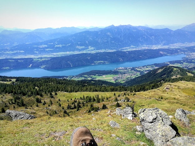 Low section of man on mountains against sky