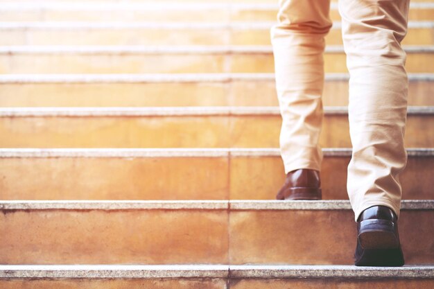 Photo low section of man moving up on steps