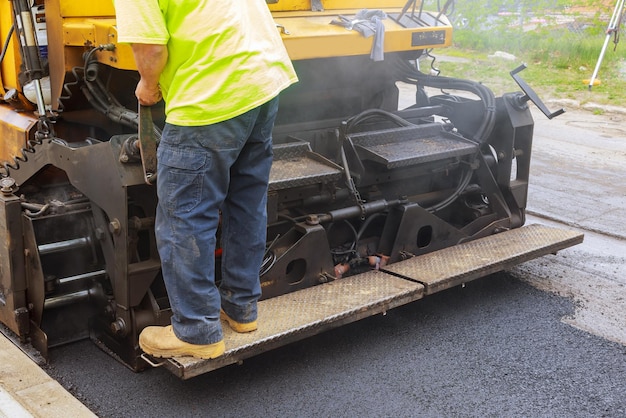 Photo low section of man operating construction machinery on road