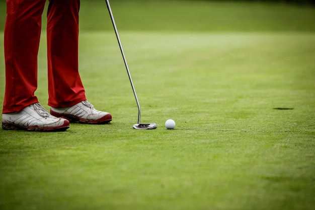 low section of man playing golf on field