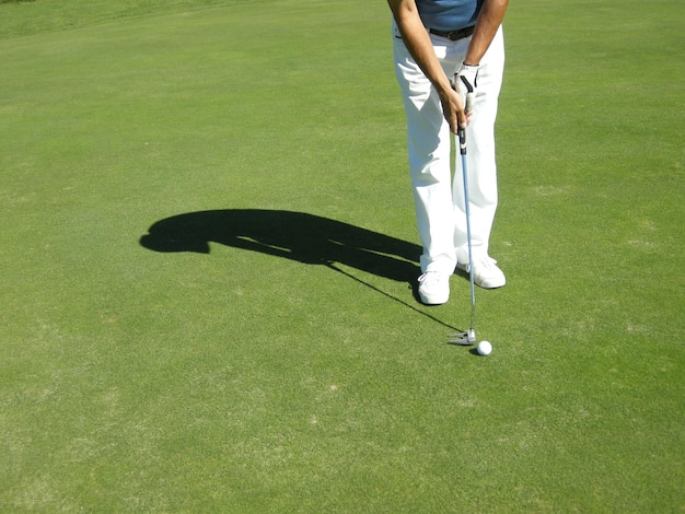 low section of man playing golf
