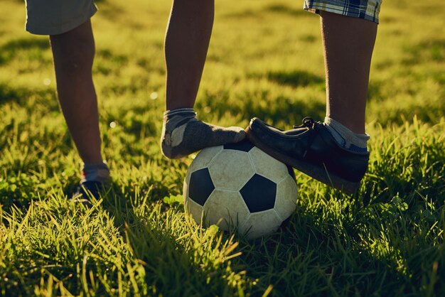 Photo low section of man playing soccer on field