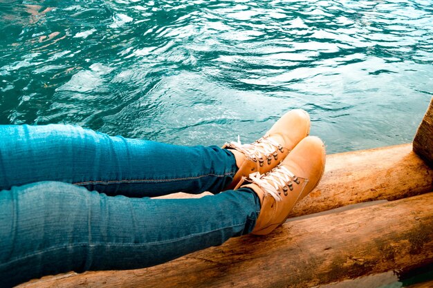 Low section of man sitting in lake