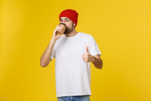 Low section of man standing against yellow background