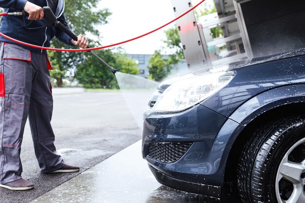 Photo low section of man standing in car