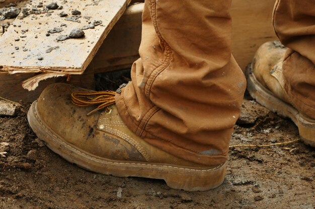 Photo low section of man standing at construction site