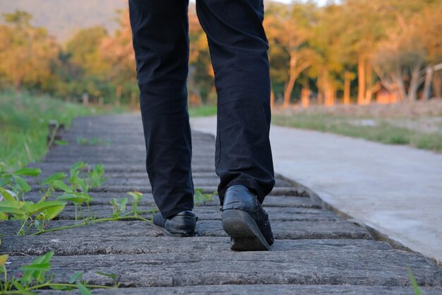 Photo low section of man standing on footpath