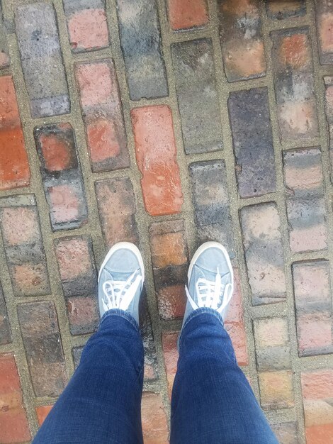 Low section of man standing on footpath