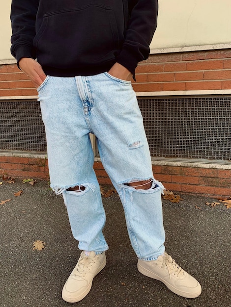 low section of man standing on footpath