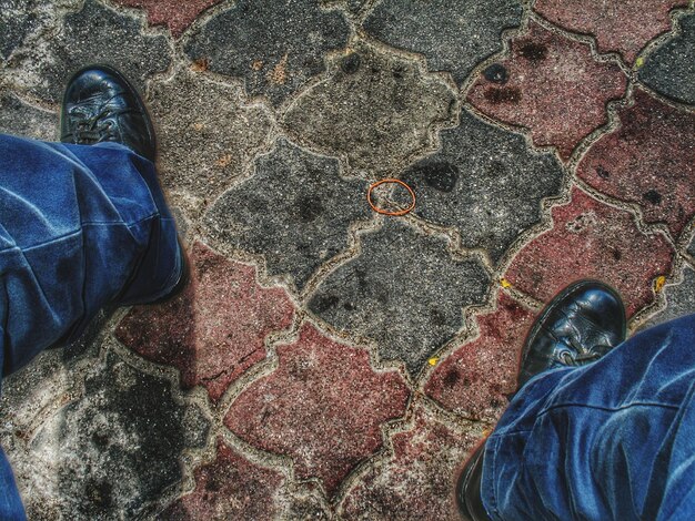 Low section of man standing on footpath