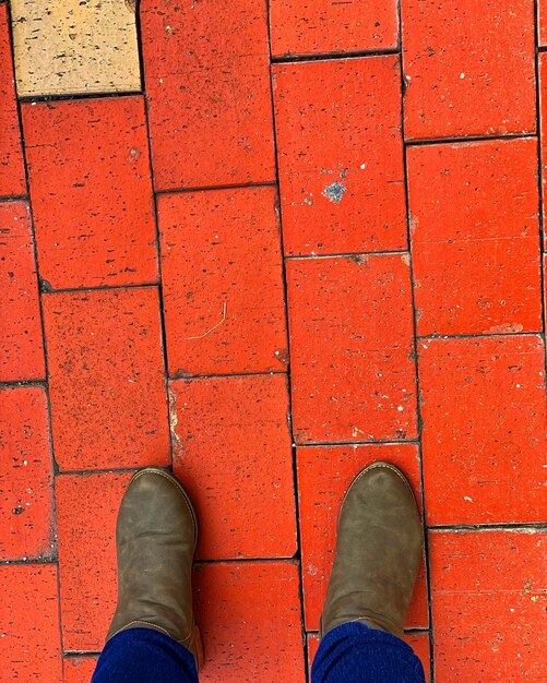 Low section of man standing on footpath