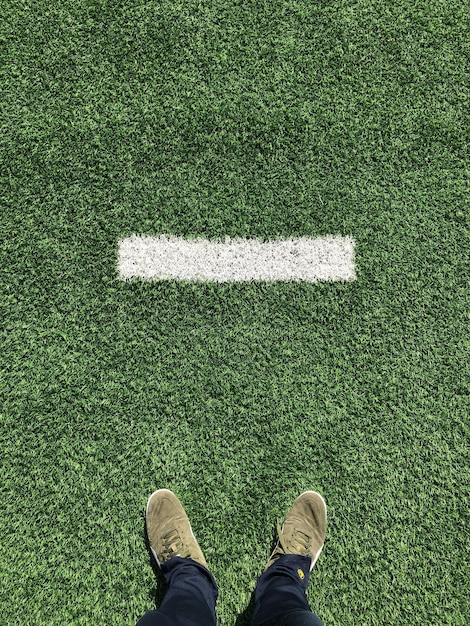 Low section of man standing on ground