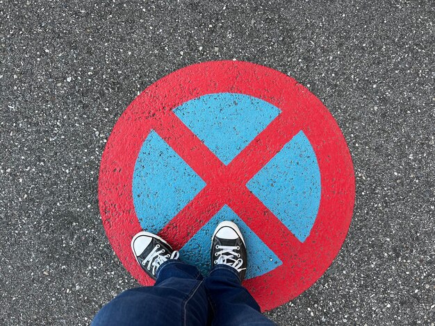 Low section of man standing on road