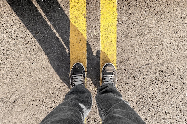 low section of man standing on road