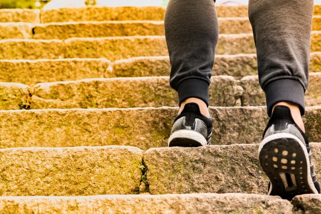 Low section of man standing on staircase