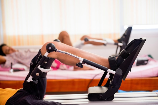 low section of man with continuous passive motion machine on hospital bed