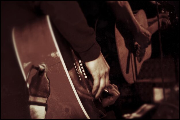 Photo low section of men playing guitar