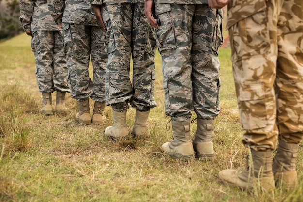 Low-section of military soldiers standing in line