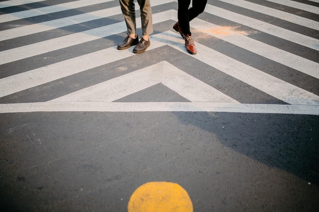 Photo low section of people crossing road