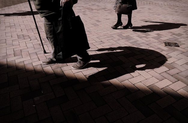 Photo low section of people on paved street