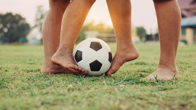 Foto sezione bassa di persone che giocano a calcio sul campo