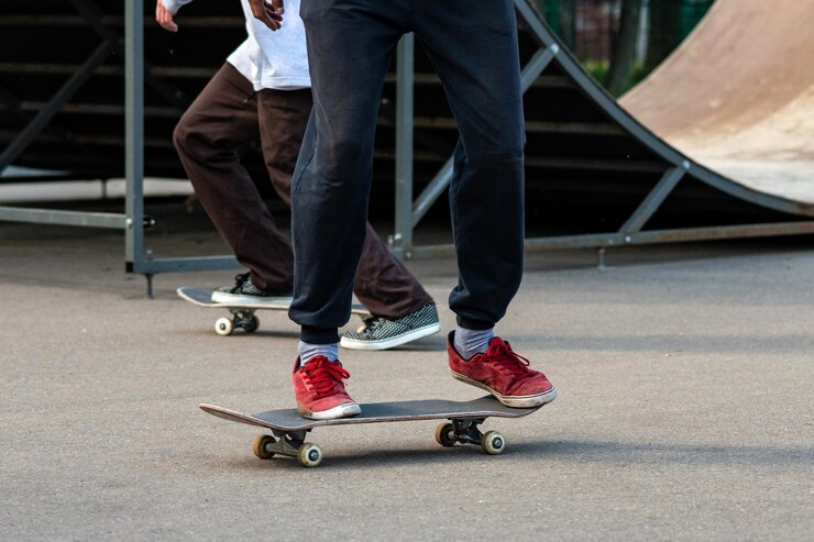 Photo low section of people skateboarding on road