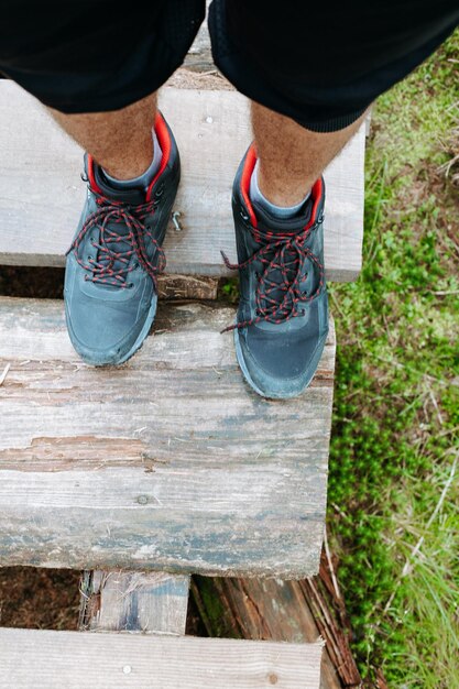 Low section of people standing on wood