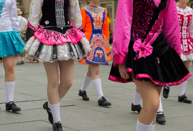 Low section of people in traditional clothing walking on street in city