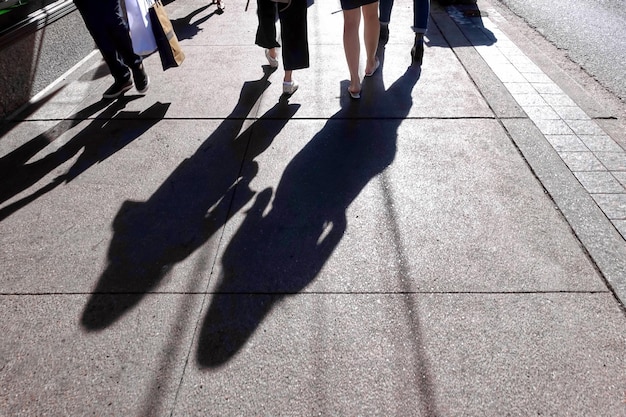 Low section of people walking on footpath