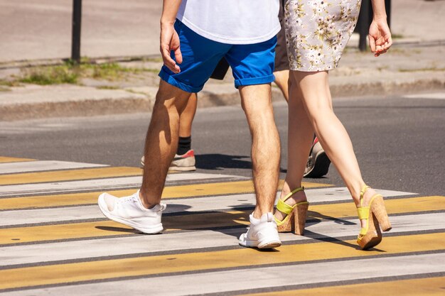 Photo low section of people walking on road