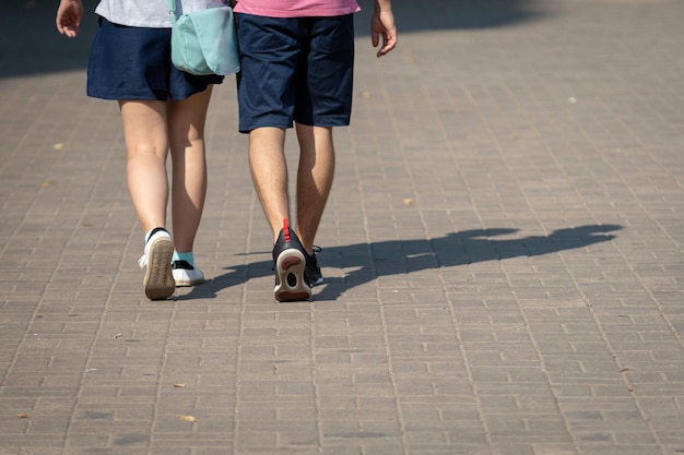 Photo low section of people walking on street