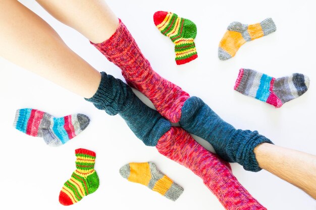 Photo low section of people wearing multi colored socks against white background