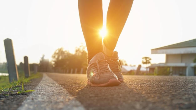low section of person against bright sun during sunset