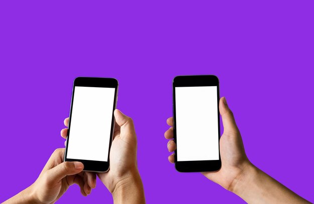 Low section of person holding mobile phone against blue background