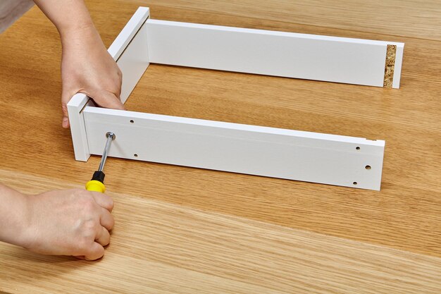 Low section of person holding paper with wooden table