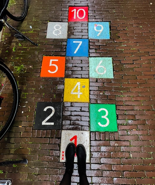 Photo low section of person standing on multi colored sign