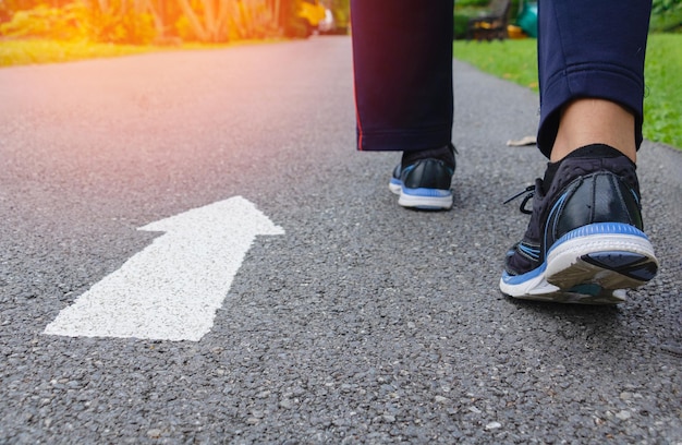 Photo low section of person standing on road