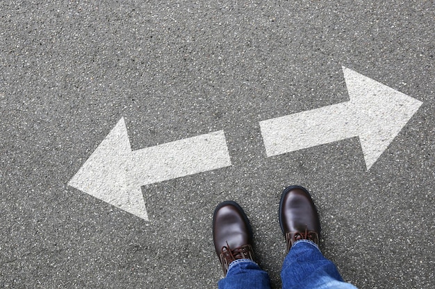 Low section of person standing on road