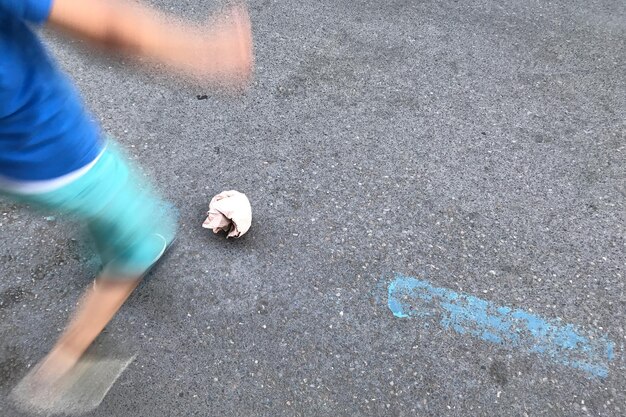 Low section of person standing on road