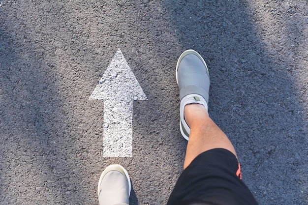 Photo low section of person standing on road