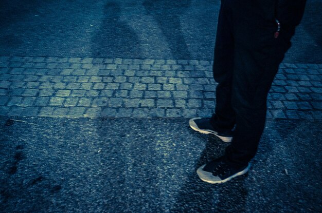 Low section of person standing on street