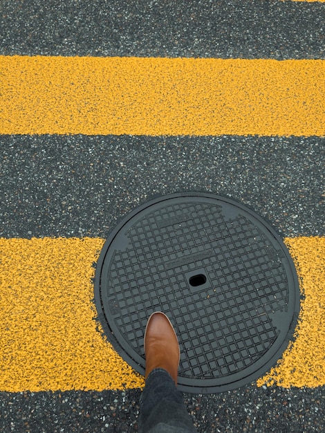 Photo low section of person standing on yellow road