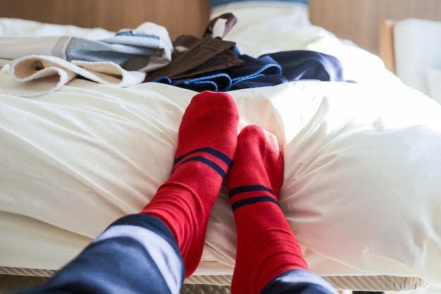 ベッドに赤い靴下を着た人の下部