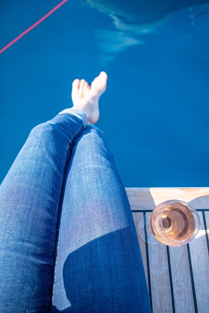 Low section of person wearing shoes by swimming pool