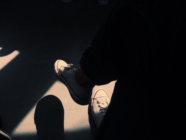 Low section of person wearing shoes on floor