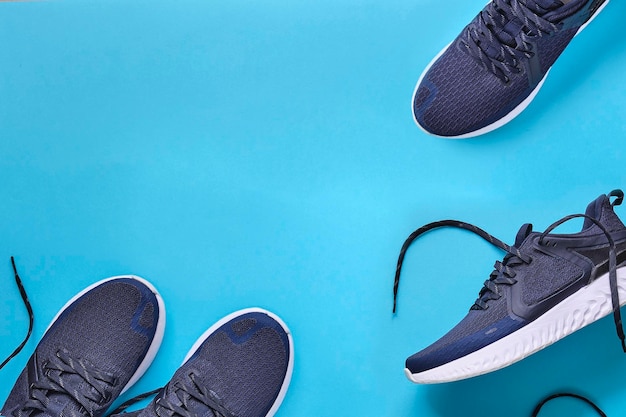 Low section of shoes against blue background