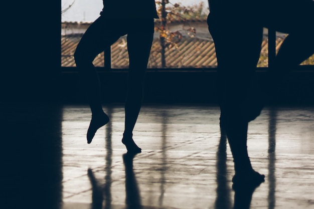 Low section of silhouette people in dance studio