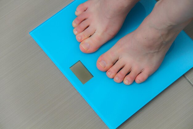 Low section of woman on blue table