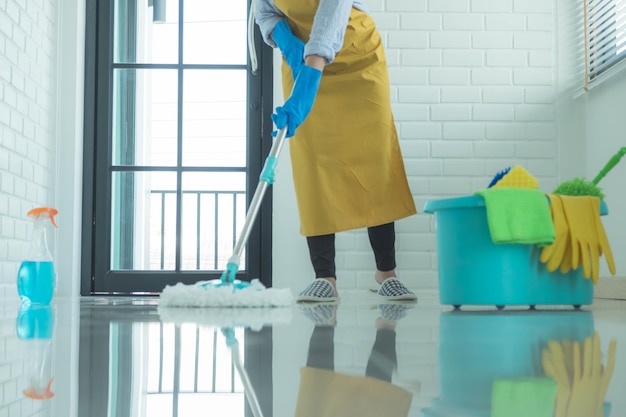 low section of woman cleaning floor at home