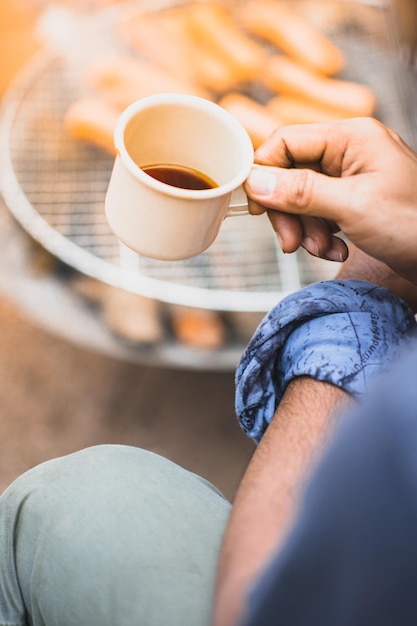 Low section of woman holding coffee cup